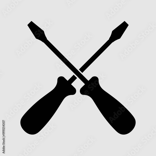 Two silhouette screwdrivers are crossed