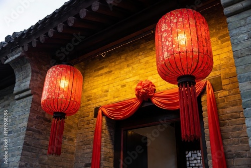 Traditional Chinese building entrance adorned with red lanterns and decorative drapery