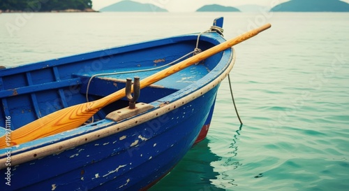 Wallpaper Mural Blue Rowboat with Wooden Oar on Calm Water Torontodigital.ca