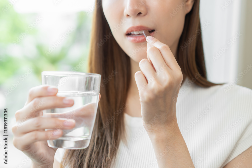 Ταπετσαρία Dietary supplement, healthy positive asian young woman hand holding herb pill, take vitamin nourish body for treatment beauty skin, taking medicine with glass of water at home