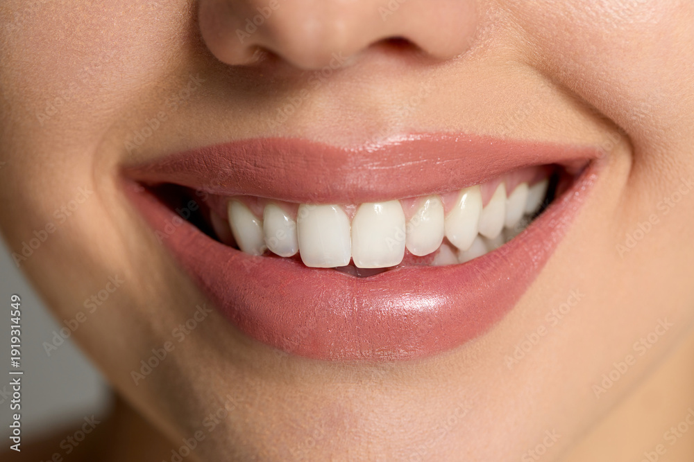 Obraz premium Closeup of woman showing smile with healthy skin and makeup in spa setting during skincare routine in a beauty moment