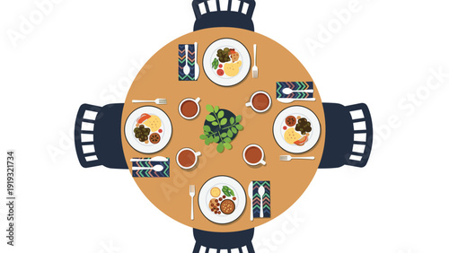 Round wooden dining table viewed from above is set with full plates of food for four people sharing a meal.
