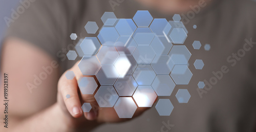 Hand touching digital hexag...