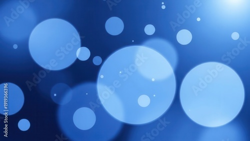 Abstract blue bokeh background with soft glowing light circles and spheres