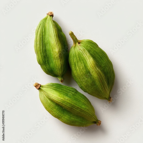Wallpaper Mural Close-up of three green cardamom pods, slightly off-white background, top-down perspective Torontodigital.ca