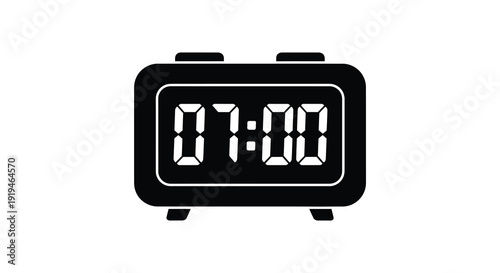 Digital clock displaying seven am a stark black form silhouette
