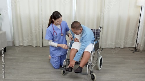 Caregiver, support worker look after senior woman patient, disability at nursing home. Elderly grandmother in wheelchair receiving physical therapy with support from female nurse therapist during the 