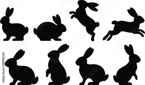 Silhouettes of rabbits in various poses on a white background black