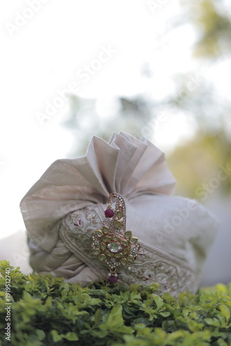 Elegant Indian Wedding Safa with Ornamental Brooch in Natural Light
