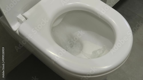 Toilet, bowl and flushing process with water, hygiene and cleanliness in bathroom. Sanitation, plumbing and modern design for home or public restroom.