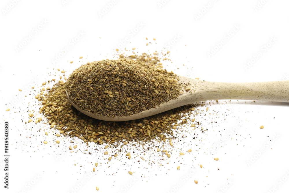 Obraz premium Za'atar pile in wooden spoon, middle eastern spice blend, isolated on white background, ( zaatar leaves, sumac, extra virgin olive oil, sesame seeds and salt ), clipping path, side view