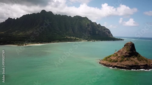 Hawaiian Mountains with an ocean around Kualoa Ranch, Oahu, drone footage, Hawaii. Majestic green mountains and turquoise ocean. Filming location in Hawaii. High quality 4k footage