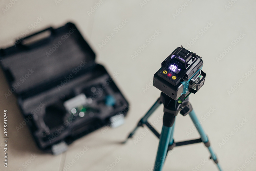 custom made wallpaper toronto digitalDigital Laser Level On Tripod With Carrying Case. Construction Tool Setup On Neutral Floor.