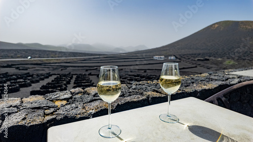 Slika na platnu A couple of glasses of white wine at a vineyard in the Canary Islands