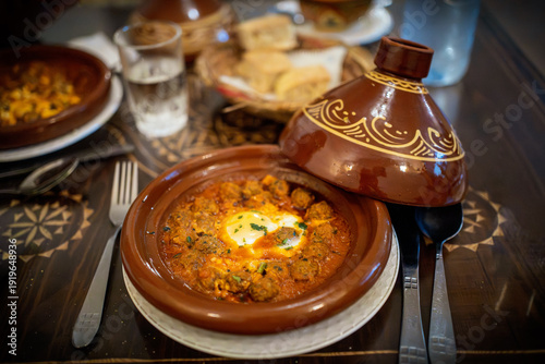 Tableau sur toile Traditional Moroccan Kefta Tagine with Poached Eggs in Tomato Sauce