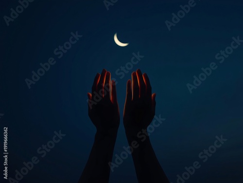 Silhouetted hands raised in prayer beneath a glowing crescent moon in the night sky.