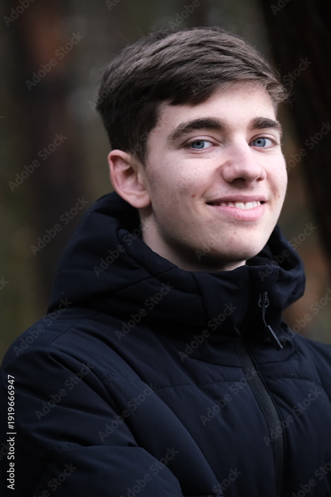 Fototapeta premium Male in black winter jacket. Smiling young guy