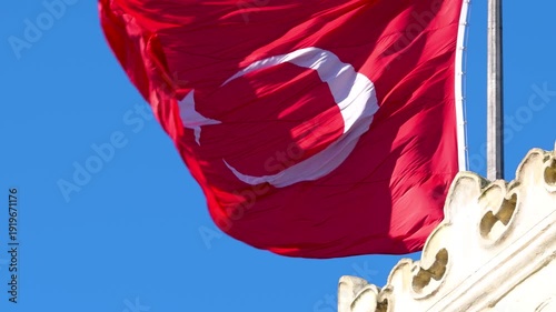 Wallpaper Mural Slow motion of the Turkish flag and the gate of Istanbul University against a cloudless blue sky. Torontodigital.ca