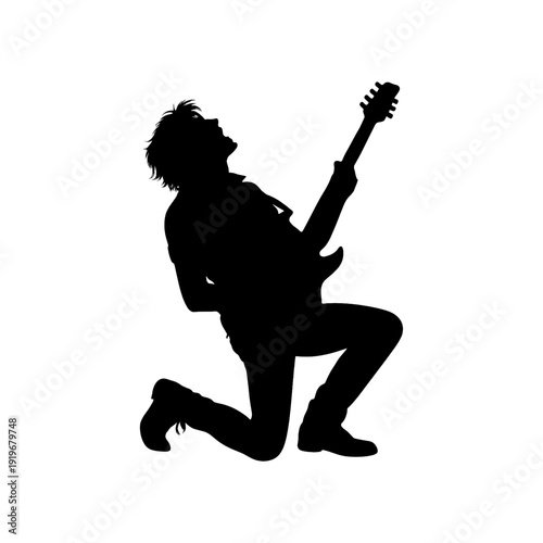 Silhouette of rock guitarist playing electric guitar on his knees
