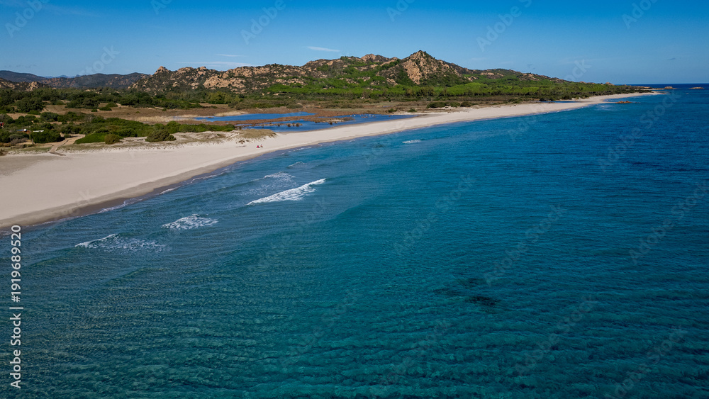 Fototapeta premium Aerial view of Berchida beach with white sand and turquoise waters, Sardinia, Italy.