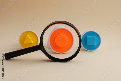 Magnifying glass finds a circle among several geometric shapes
