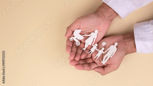 Obraz na plátně Paper family cutout in doctor hands showing protection and care for future home