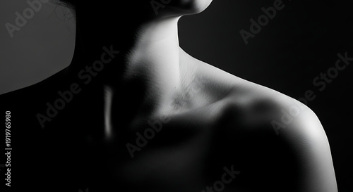 Monochrome portrait of a woman's neck and shoulder.