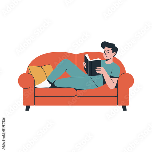 Young man is relaxing comfortably while absorbed in reading a paperback book on a sofa.
