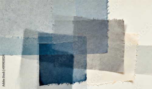 Abstract composition of layered blue and gray fabric swatches with frayed edges on a neutral background