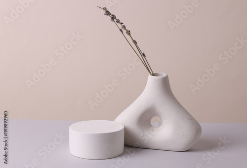 Creative design minimalist plaster vase with dry grass and podium on pastel background. Product presentation