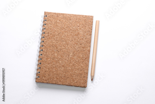 Bild auf Leinwand Cork cover spiral notebook with wooden pencil on white background