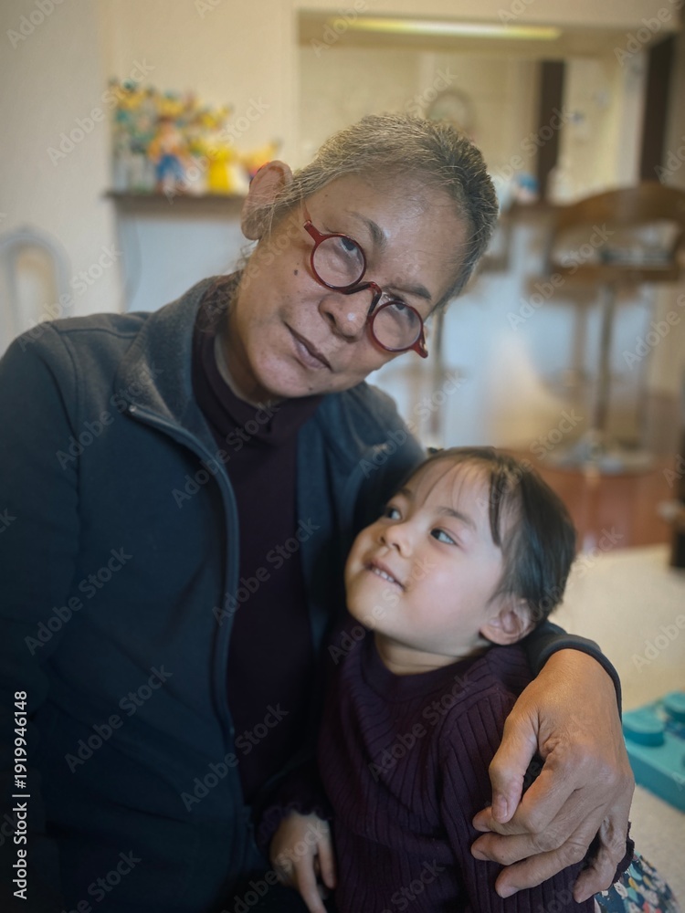 Obraz premium A heartwarming bond between grandmother and granddaughter. Gentle hair braiding and tender embraces capture the essence of family love, generational wisdom, and cozy home moments. Pure affection.