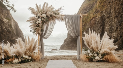 Beach wedding ceremony arch adorned with pampas grass and floral arrangements