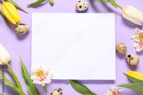 Composition with blank card, flowers and Easter eggs on lilac background