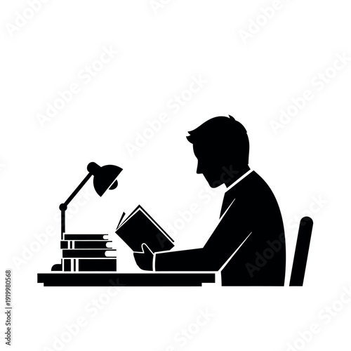 Silhouette of a man reading a book at a desk under a lamp.