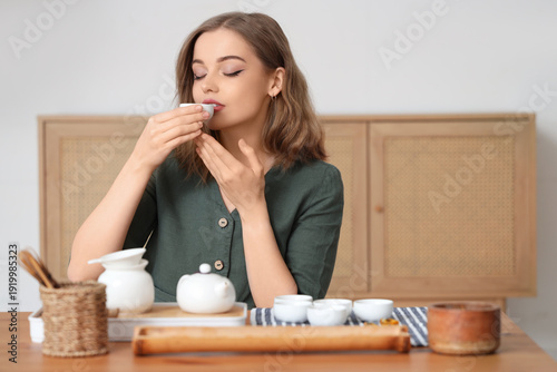 Beautiful young woman drink...
