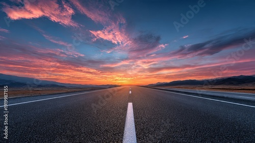 Open road stretching to horizon during sunset with dramatic sky, journey and freedom concept