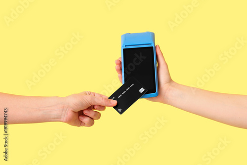 Hand of customer paying wit...