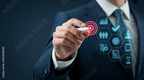 Businessman in suit interacting with digital business icons on screen