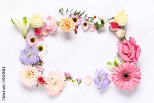 Frame made of different beautiful flowers on white background