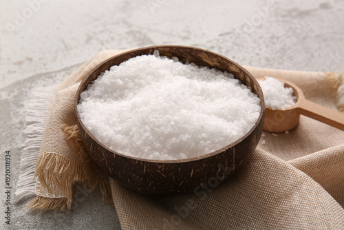 Photos Bowl with sea salt, scoop and napkin on grunge background