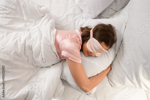 Young woman with mask sleep...
