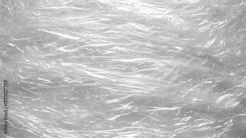 Close-up texture of crumpled transparent plastic wrap, providing a detailed background for packaging or design.
