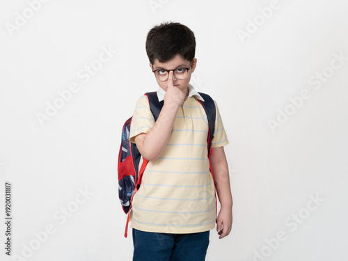 Young Schoolboy Adjusting His Glasses While Wearing a Backpack