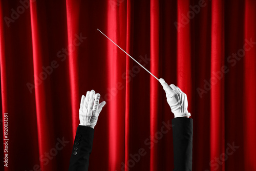 Conductor's hands with bato...