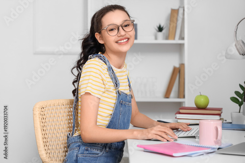 Teenage girl with computer ...