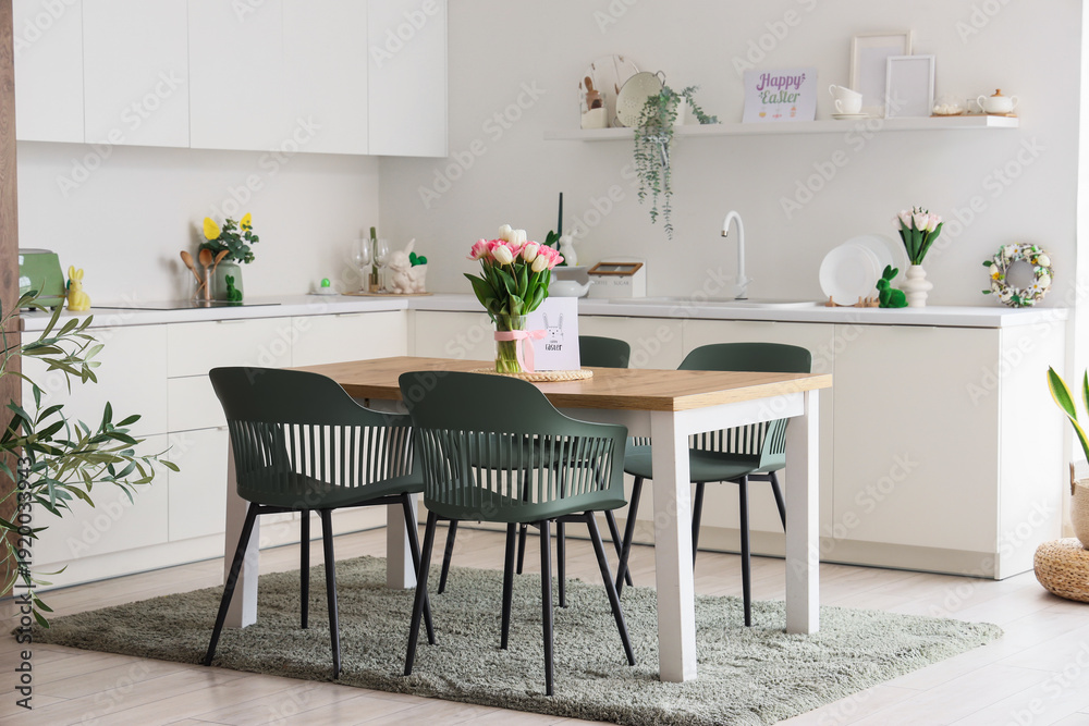 Fototapeta premium Interior of light kitchen decorated for Easter with dining table and counters