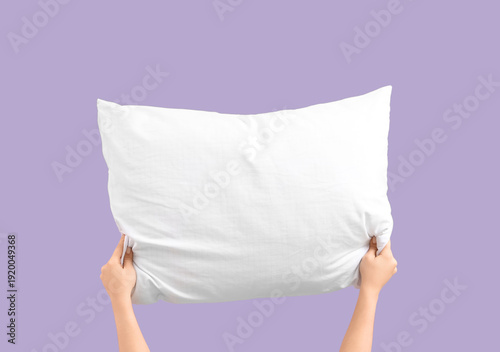 Woman holding soft pillow o...