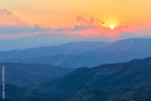 Scenic view of dramatic sky over mountain during sunset