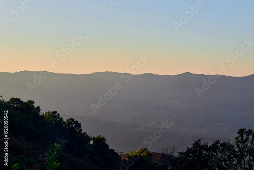 Scenic view of warm sunlight on tropical mountain during sunset